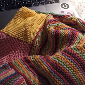 up close of some multicolored knitting, striped rows of garter stitch